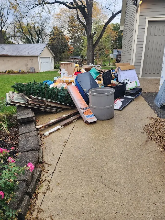 Dumpster being loaded with debris for Estate Cleanout Dumpster Rental in Suncoast Estates